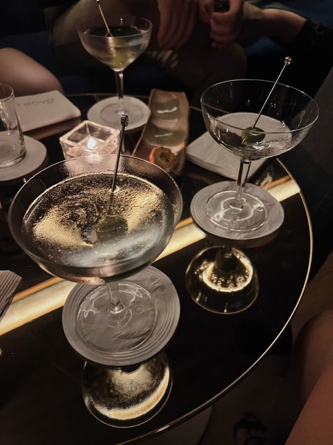 Martinis on a dark bar table at night