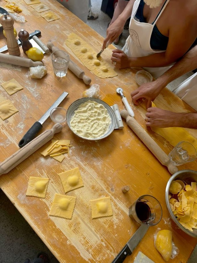 Ravioli being made by hand on a wooden board